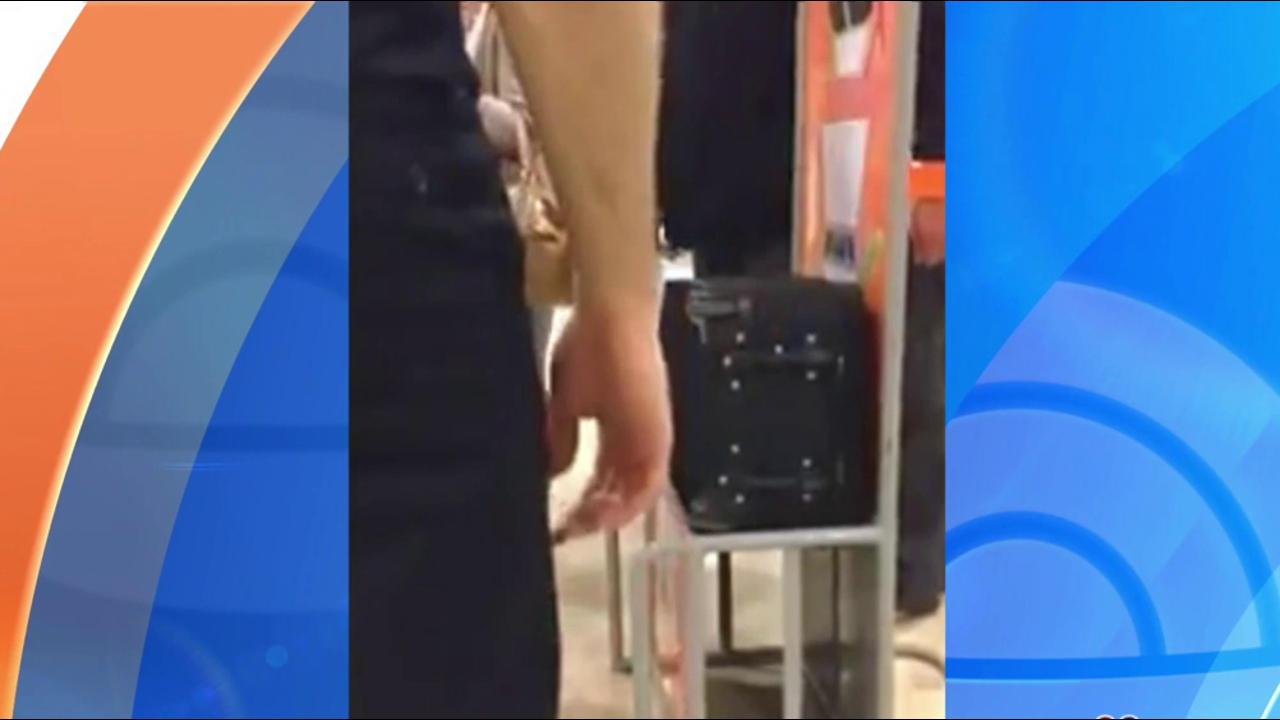 Watch this passenger stomp on his carry-on bag to make it fit