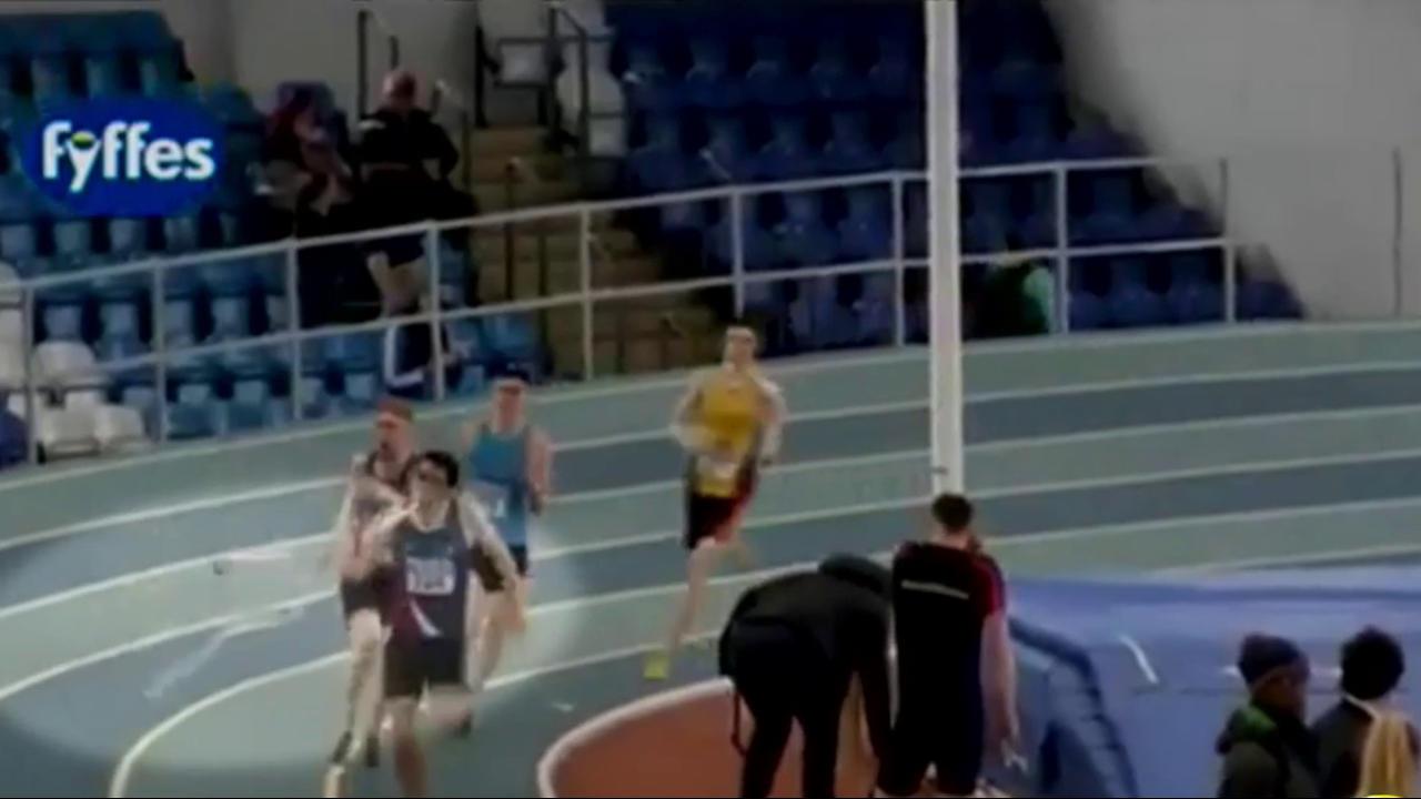 Watch runner get snagged by a rubber band on his way to finish line