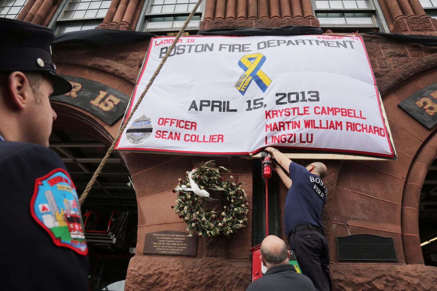 Image: A Boston firehouse that  lost two of its own in a fire last month — Engine 33, Ladder 15 — pays tribute to the marathon victims