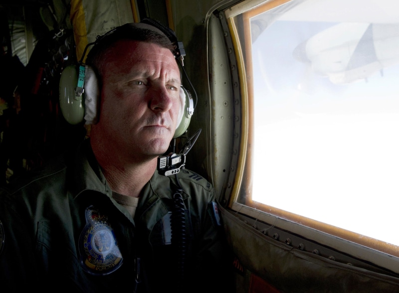 Image: Royal Australian Air Force loadmaster Flight Sergeant John Mancey scans the ocean