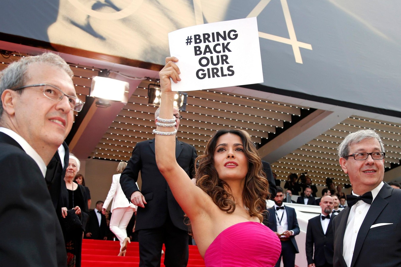 Image: Actress Salma Hayek holds a placard which reads 'Bring back our girls'at the 67th Cannes Film Festival in Cannes