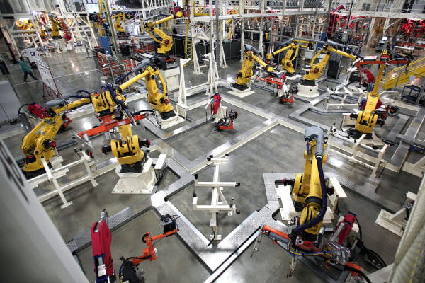 Image: Robots are shown on the assembly line of the new 2015 Chrysler 200 at the Sterling Heights Assembly Plant on March 14 in Sterling Heights, Mich.