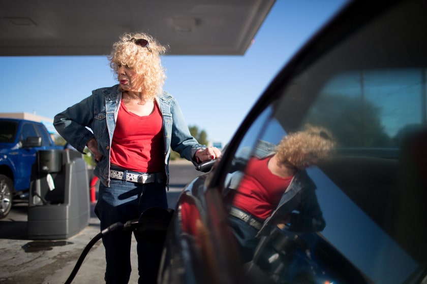 Image: Denee Mallon pumps gas into her Ford Mustang in Albuquerque, New Mexico.