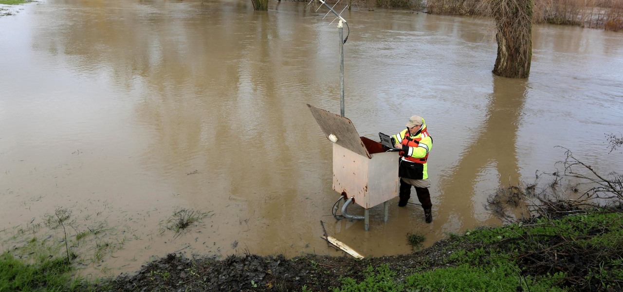 Image:  Eric Lindbloom of the U.S. Geological Survey checks a water metering station along Cache Creek near Woodland, Calif.
