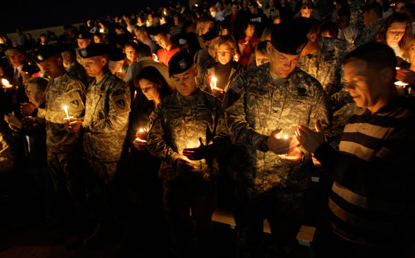 Image: Soldiers hold a candle light vigil 