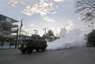 Image: A military truck carries out fumigation in a neighborhood to stop the breeding of the dengue mosquito in Havana