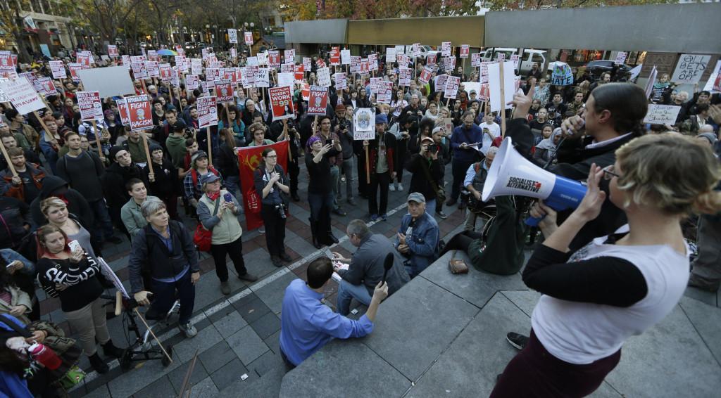 Seattle's Socialist Alternative organize anti-Trump rally. Note the manufactured signs and the hammer & sickle logo.