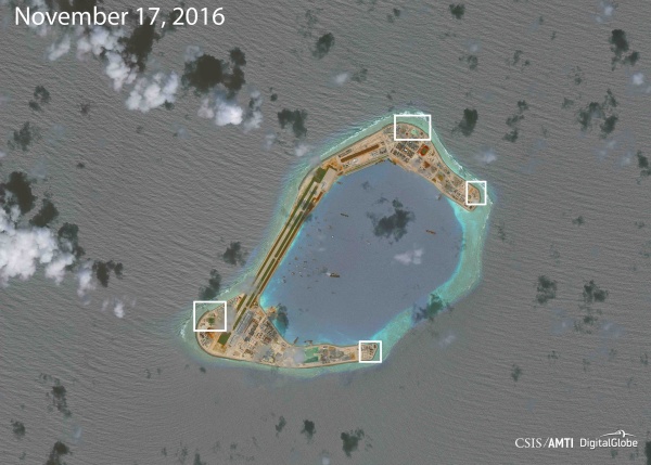 Image: A satellite image shows what CSIS Asia Maritime Transparency Initiative says appears to be anti-aircraft guns and what are likely to be close-in weapons systems (CIWS) on the artificial island Subi Reef in the South China Sea