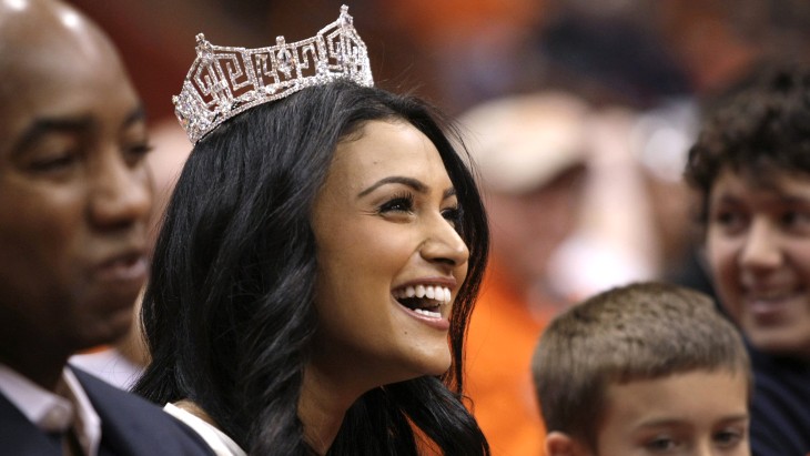 Miss America 2014 Nina Davuluri attends the NCAA college basketball game Syracuse and North Carolina State in Syracuse, N.Y., Saturday, Feb. 15, 2014....