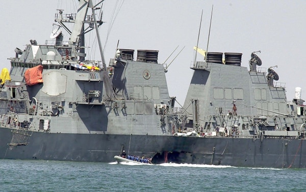 Image: Investigators in a speed boat examine the hull of the USS Cole at the Yemeni port of Aden