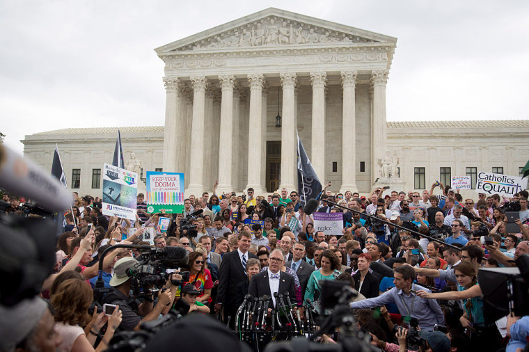 Plaintiff Jim Obergefell, bottom center, speaks to the media outside the Supreme Court after the Obergefell vs. Hodges gay marriage ruling on Friday, June 26, 2015. 