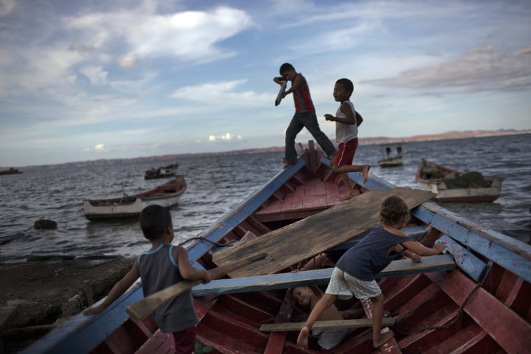 Image: Children play "pirates" on a fishing boat
