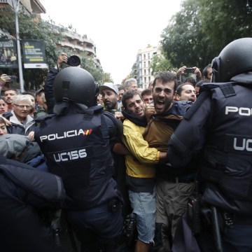 Image: Catalans and police clash outside the Ramon Llull school.