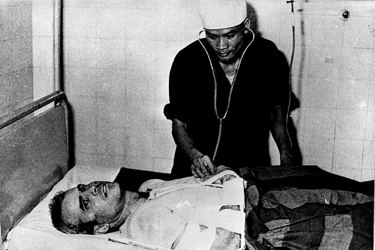 Image:  A Vietnamese doctor examines John McCain