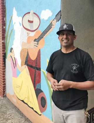 Tomas Delgado is photographed in front of Candelas Guitars, in the neighborhood of Boyle Heights, in Los Angeles. Courtesy Rebekah Sager