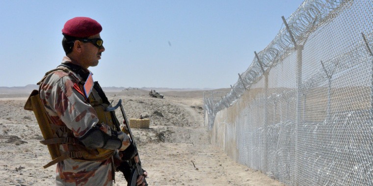 Image: A Pakistani army soldier stands guard along with border fence at the Pakistan-Afghanistan border near the Punjpai area of Quetta in Balochistan on May 8, 2018.