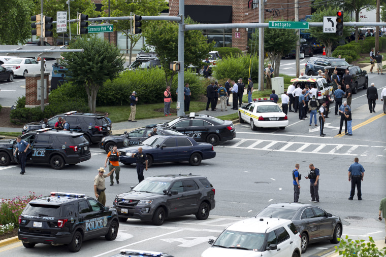 Image: Maryland police officers block the intersection at the building entrance