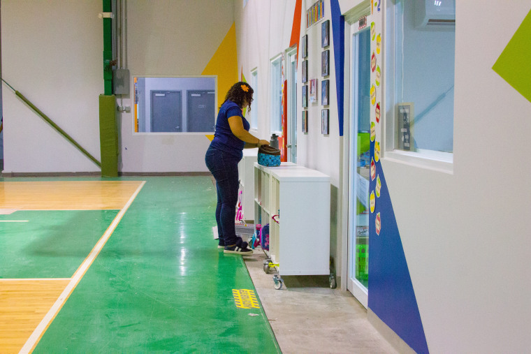 A teacher organizes her student's 'cubbies' at Vimenti, Puerto Rico's first charter school, during orientation week. 