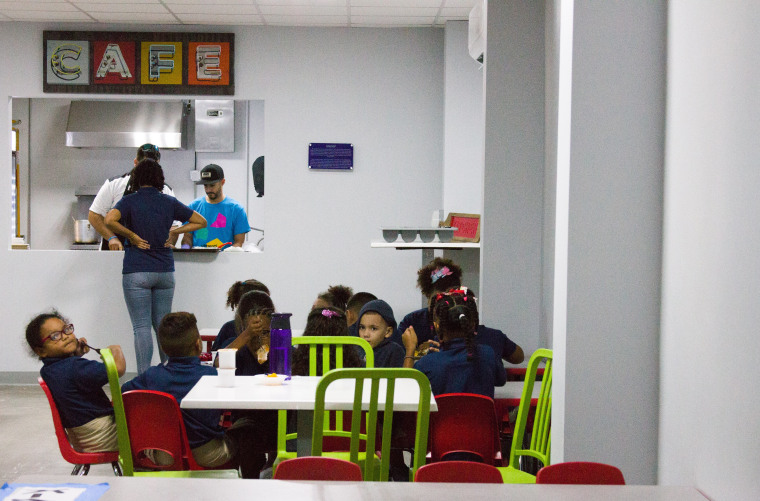 Kids have lunch at the cafeteria in Vimenti, Puerto Rico's first charter school, during orientation week.