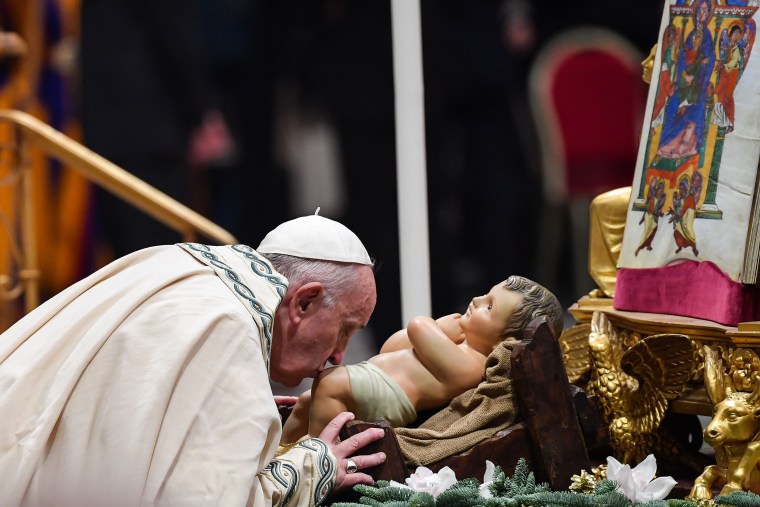 Pope Francis kisses the baby Jesus Christ during the 