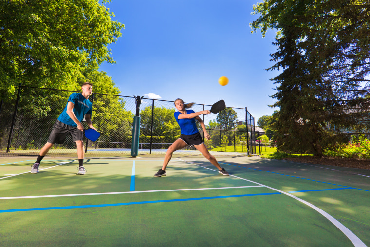 Image: Young Man and Woman Playing Pickleball in Court
