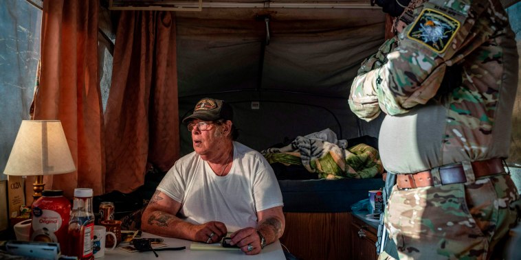 Image: Striker, the leader of the Constitutional Patriots militia, speaks with Viper, right, about logistics in Anapra, New Mexico, on March 20, 2019.