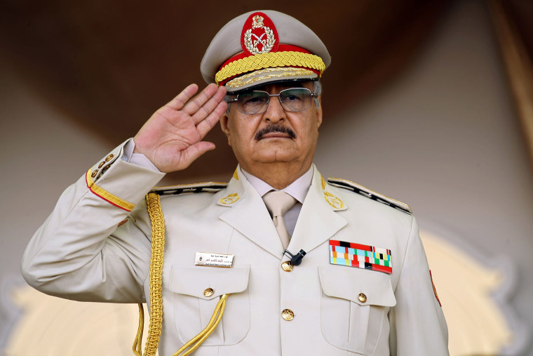 Image: Libyan Strongman Khalifa Haftar salutes during a military parade in the eastern city of Benghazi