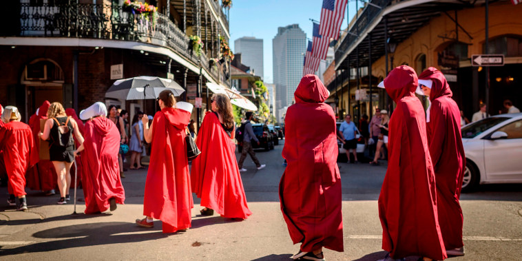 Image: Handsmaid themed protesters march down the French Quarter of New Orleans, Louisiana