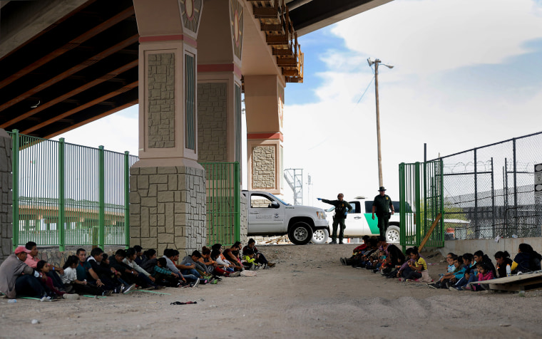 Image: Border Patrol agents watch over detained migrants near El Paso, Texas, on May 19, 2019.