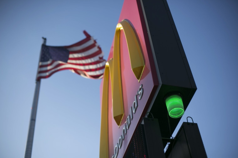 Image: A green light is illuminated on a McDonalds in Detroit