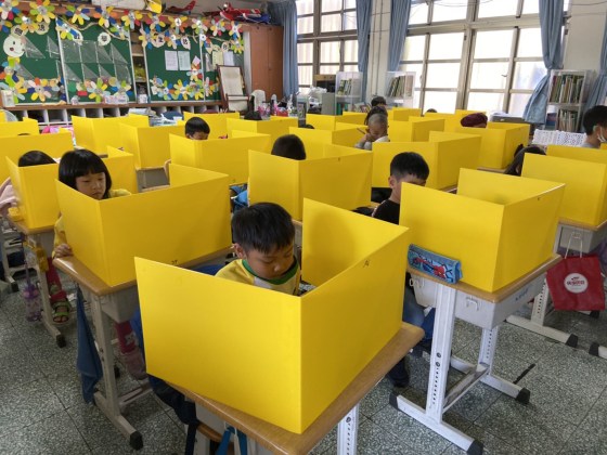 Image: Schoolchildren use plastic dividers at a school in Taiwan.