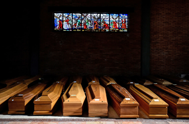 Image: Coffins of people who have died from coronavirus disease (COVID-19) are seen in the church of the Serravalle Scrivia cemetery