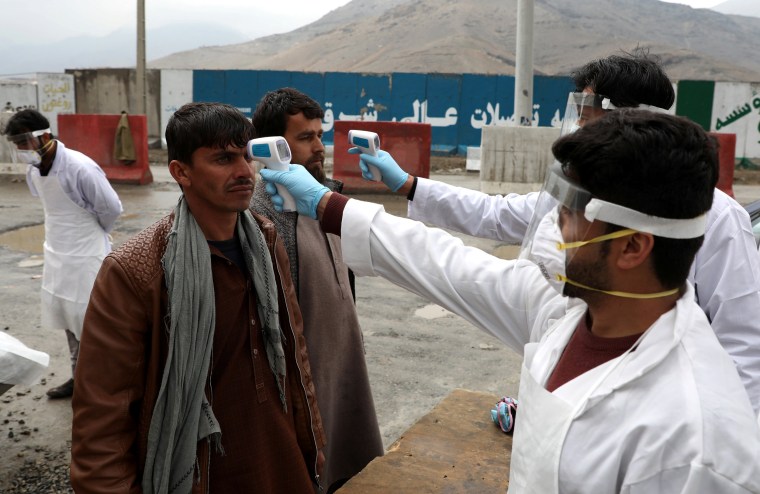 Image: Medical workers check temperatures