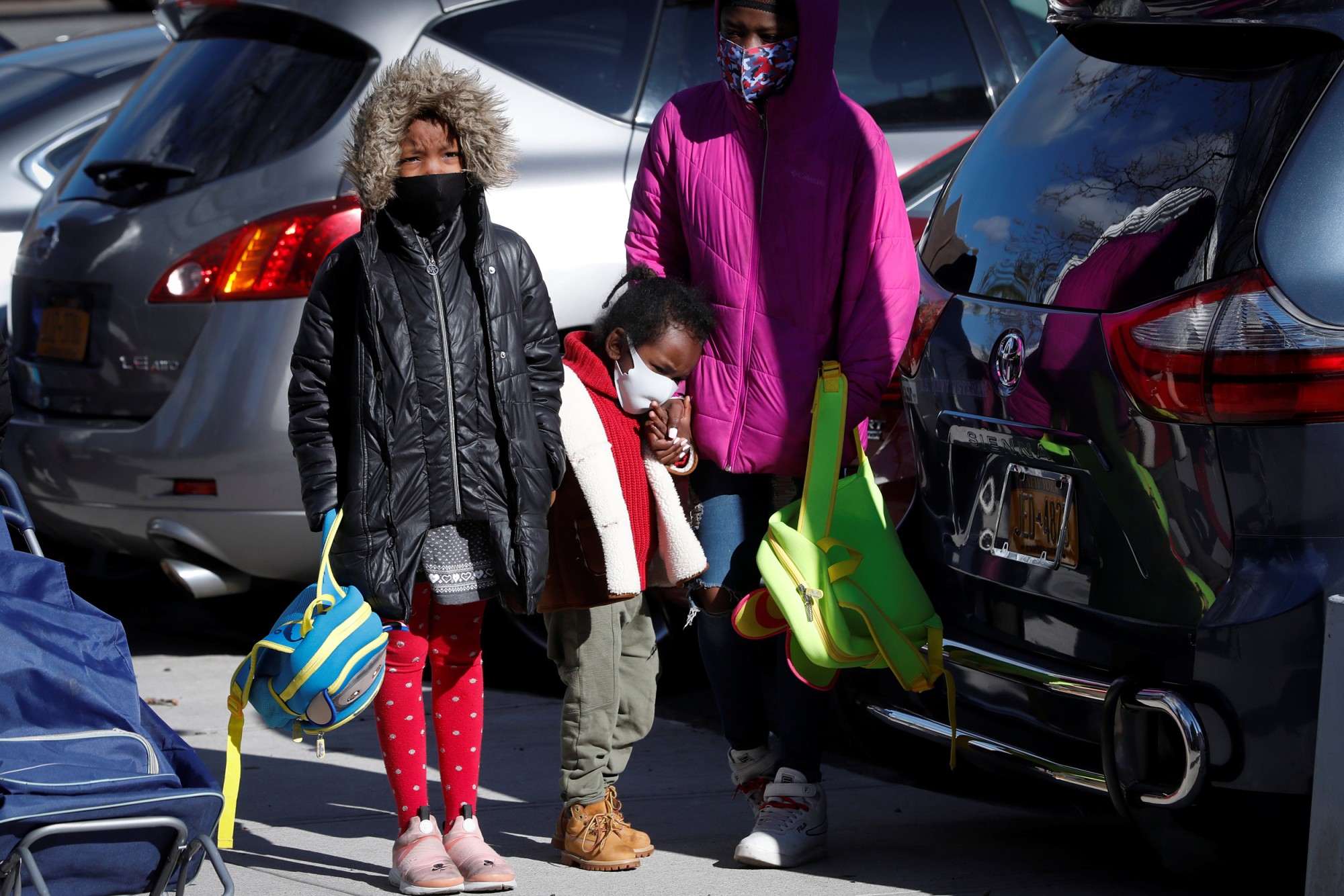 Children wait in line to pick up packages of free food during a food rescue operation run by City Harvest during the outbreak of the coronavirus in the Bronx, N.Y. on April 22, 2020.Mike Segar / Reuters