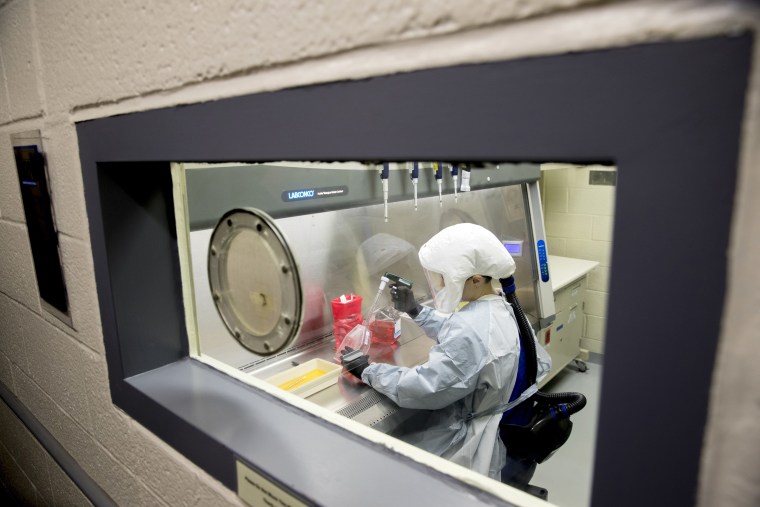 Laboratory scientist Andrea Luquette cultures coronavirus to prepare for testing at U.S. Army Medical Research and Development Command at Fort Detrick, Md., on March 19, 2020.Andrew Harnik / AP file