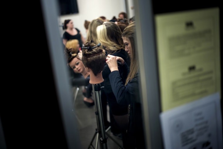 Image: Students practice cutting hair at a Paul Mitchell School in Virginia in 2013.