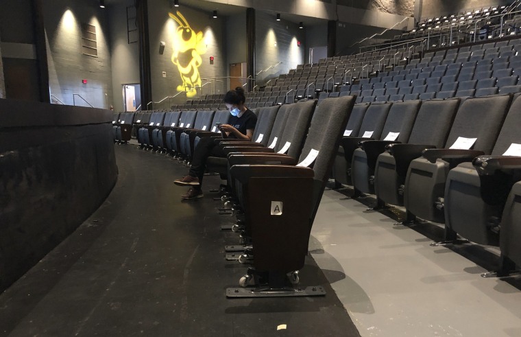 Image: A graduate assistant sits in an empty auditorium during an online lecture on the first day of classes Monday, Aug. 17, 2020, at Georgia Tech in Atlanta.