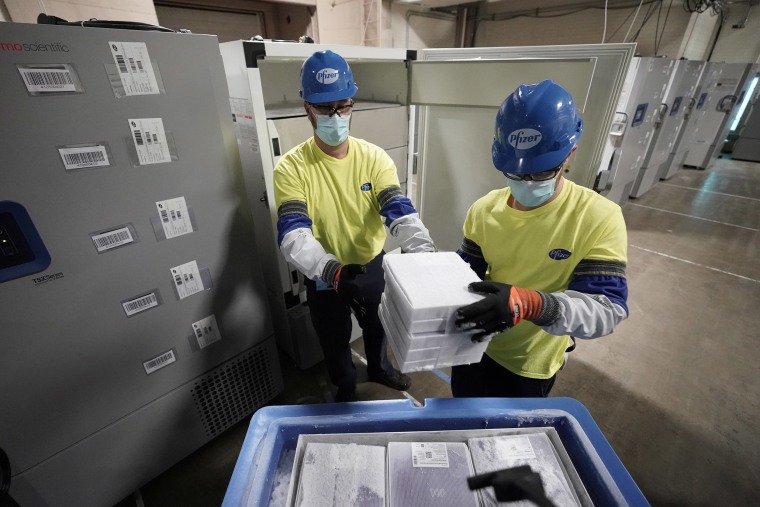 Image: Boxes containing the Pfizer-BioNTech COVID-19 vaccine are prepared to be shipped at the Pfizer Global Supply Kalamazoo manufacturing plant in Portage, Mich.