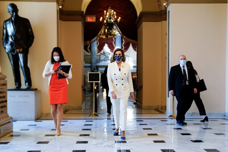 Image: Speaker of the House Pelosi walks to the House floor for the final vote on President Biden's coronavirus (COVID-19) relief bill at the U.S. Capitol in Washington