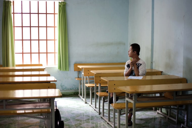Image: Chu Thanh Nhan, 12, in an empty classroom at a rehabilitation center in Danang, Vietnam, in 2012.