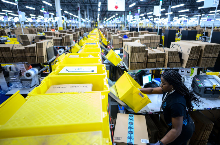 A woman works at a packing station at the 855,000-square-foot Amazon fulfillment center in Staten Island, N.Y., on Feb. 5, 2019.