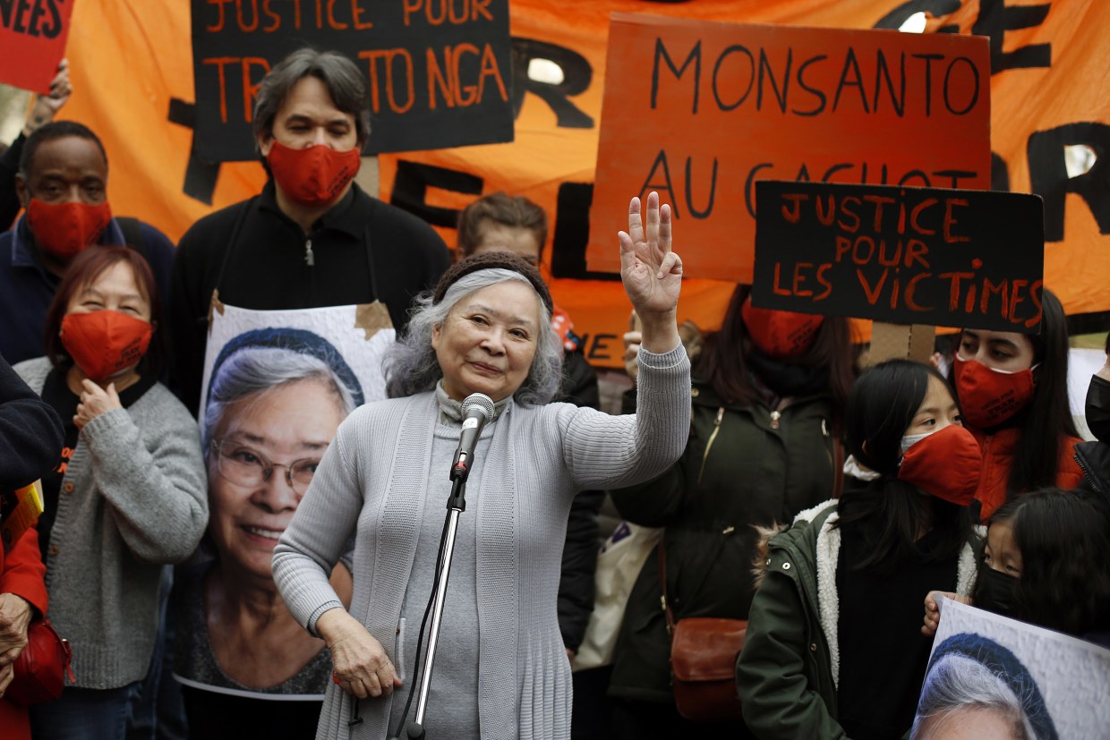 Image: Tran To Nga, a 78-year-old former journalist, waves as she delivers a speech during a gathering in support of people exposed to Agent Orange during the Vietnam War, in Paris