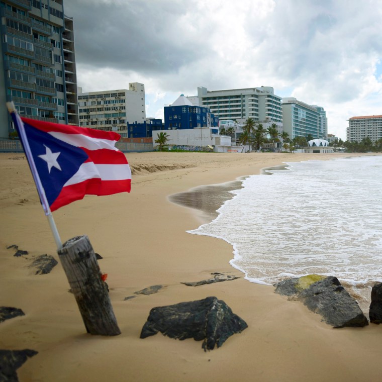 A Puerto Rican flag on an empty beach at Ocean Park, in San Juan, Puerto Rico, on May 21, 2020.