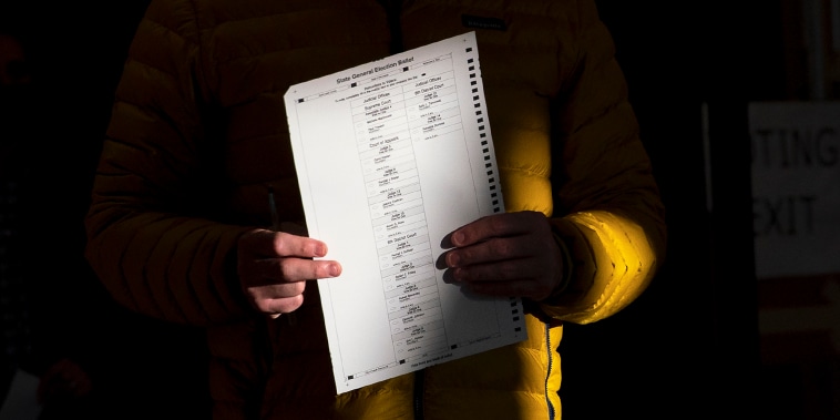Image:  A voter holds a ballot on Nov. 3, 2020 in Minnesota.