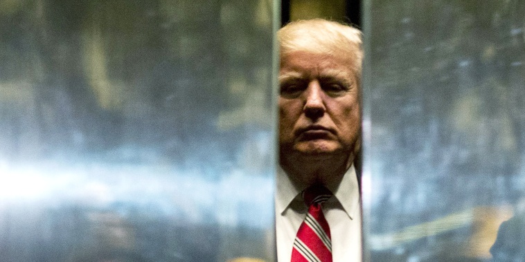 US President-elect Donald Trump boards the elevator after escorting Martin Luther King III to the lobby after meetings at Trump Tower in New York City on January 16, 2017.