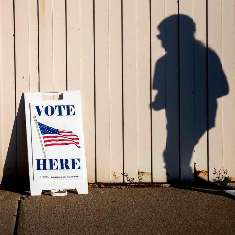 Image: A voter walks toward the entrance of the Boys and Girls Clubs of the Great Lakes Bay Region to cast their ballot in Bay City, Mich., during Election Day on Nov. 3, 2020.