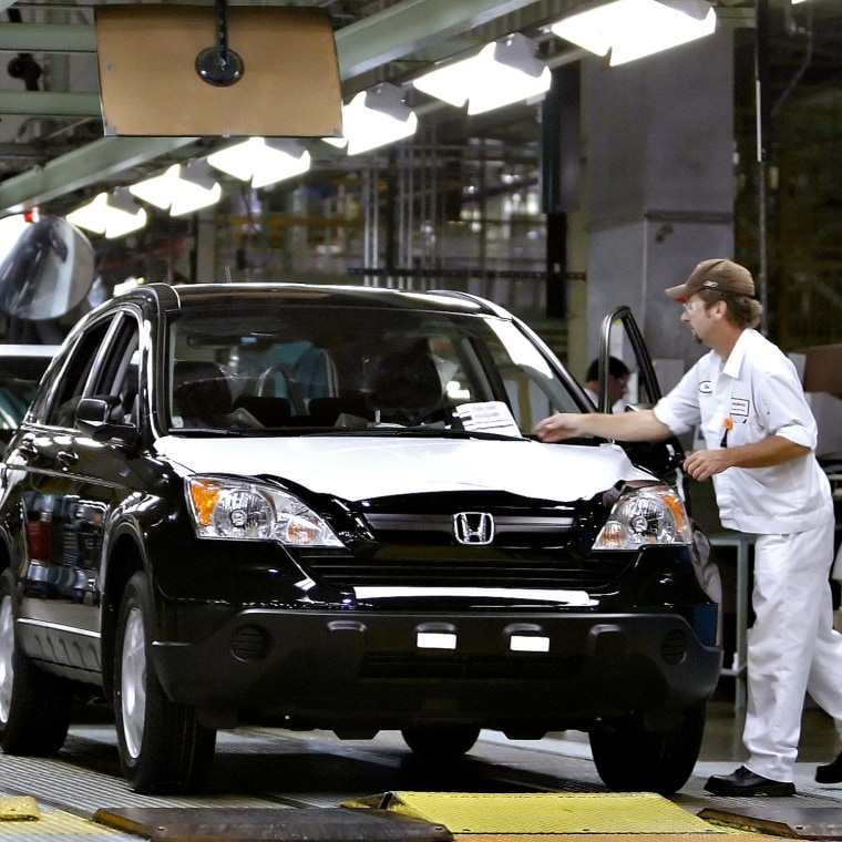 People prepare Honda CRVs on production line